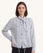 Light blue plaid tie-neck button-up blouse with long sleeves and button front