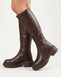 Brown knee-high platform boots with chunky lug sole and block heel, faux leather