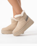 Beige platform snow boots in faux suede with faux fur trim and slip-on ankle silhouette