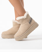 Beige platform snow boots in faux suede with faux fur trim and slip-on ankle silhouette