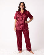 Women's satin pajama set in burgundy: short-sleeve button top and matching pants