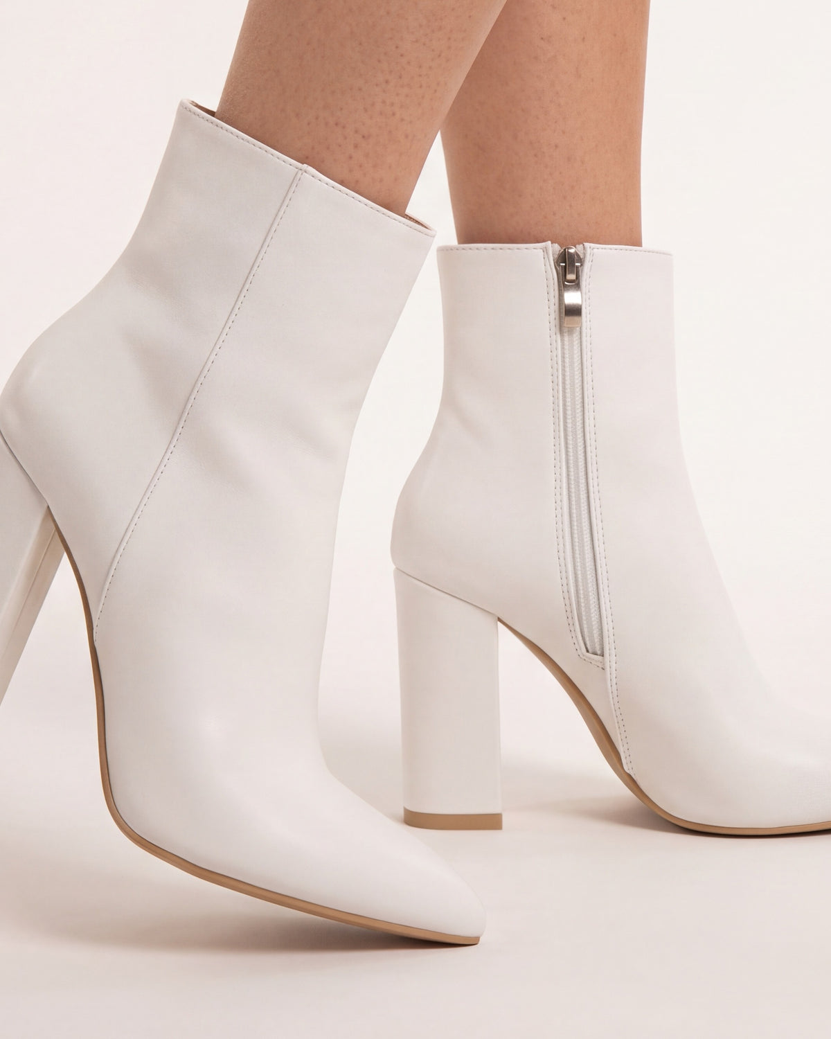 Pointed Toe Ankle Boots for Women — Block Heel Booties with Side Zip in Faux Leather in White — studio model photo [ai-studio]