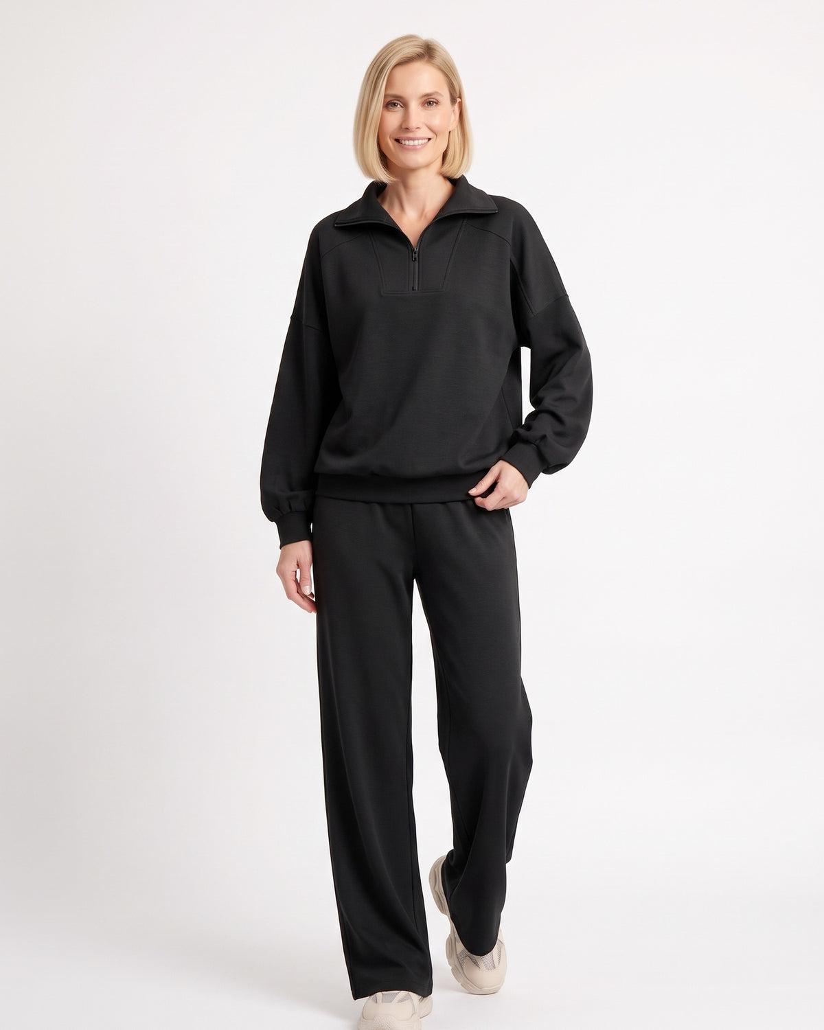 Black two-piece sweatsuit with quarter-zip pullover and wide-leg pants