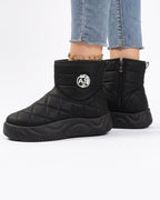Quilted black platform ankle boots with side zip and fleece lining, logo patch