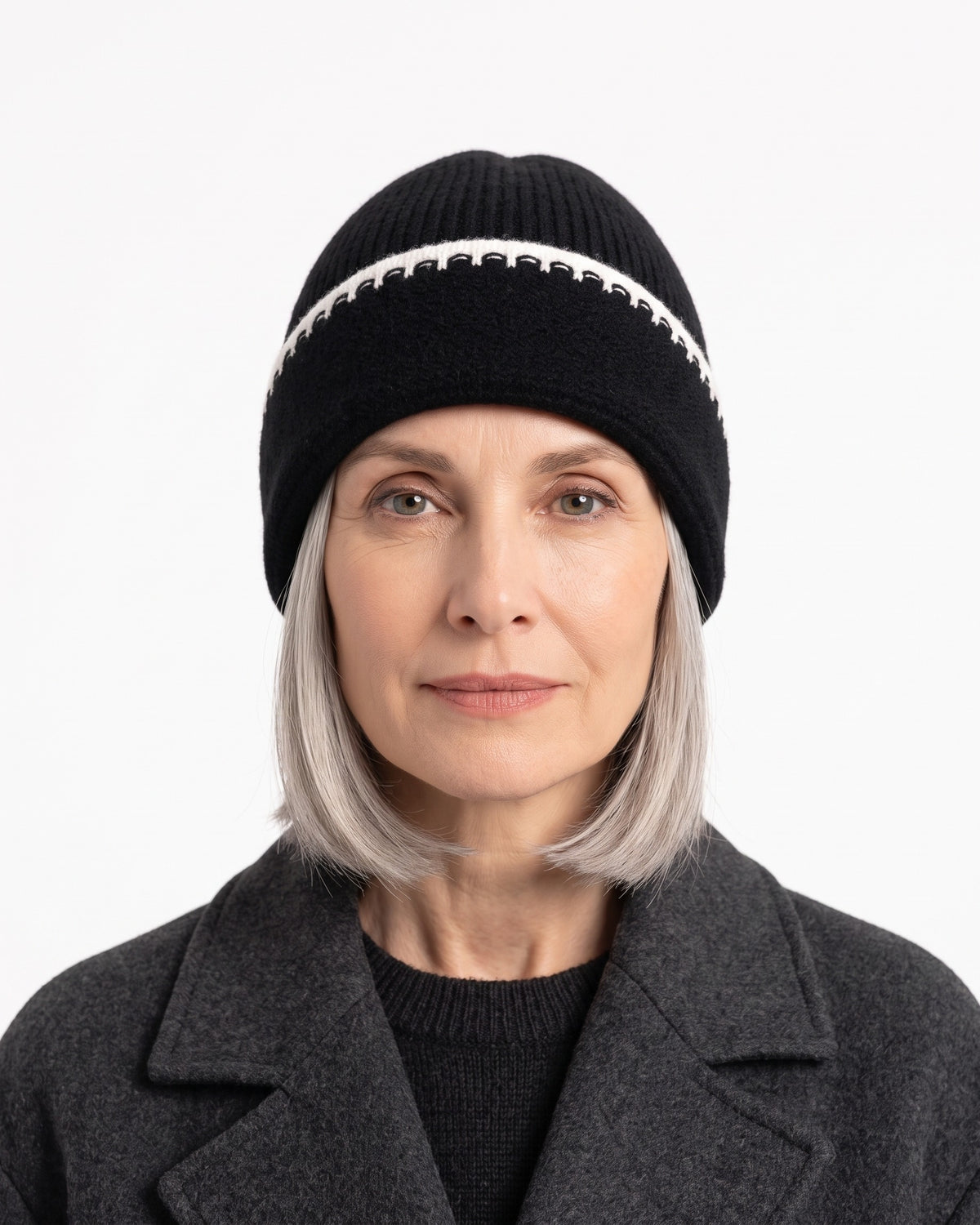 Black ribbed knit beanie with white contrast stitch trim and folded cuff