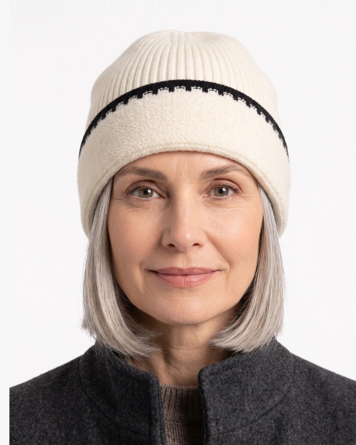 Cream ribbed knit beanie with black contrast stitch trim and folded cuff