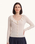 White knit cardigan with ruffle V-neck collar, button front, long sleeves