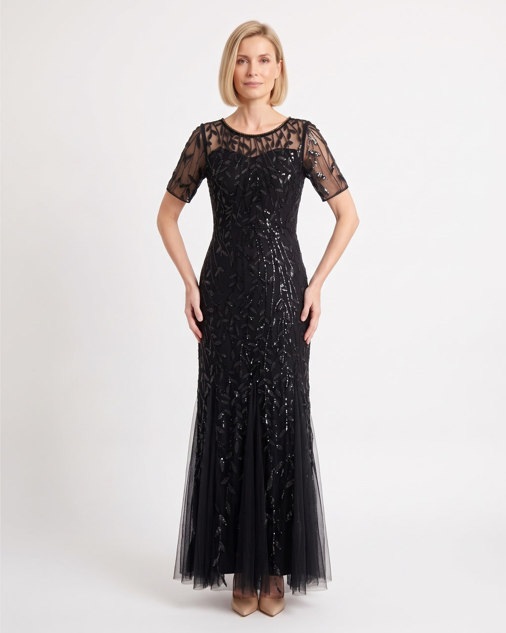 Black sequin mermaid gown with leaf embroidery, sheer short sleeves, and a tulle maxi skirt