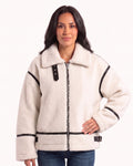 Women’s white sherpa aviator jacket with black trim, front zipper, and buckle collar