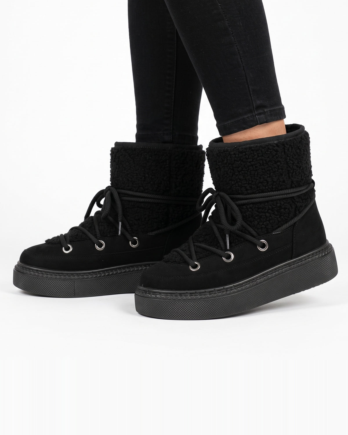 Black lace-up platform snow boots with sherpa-lined ankle cuff and wrap laces