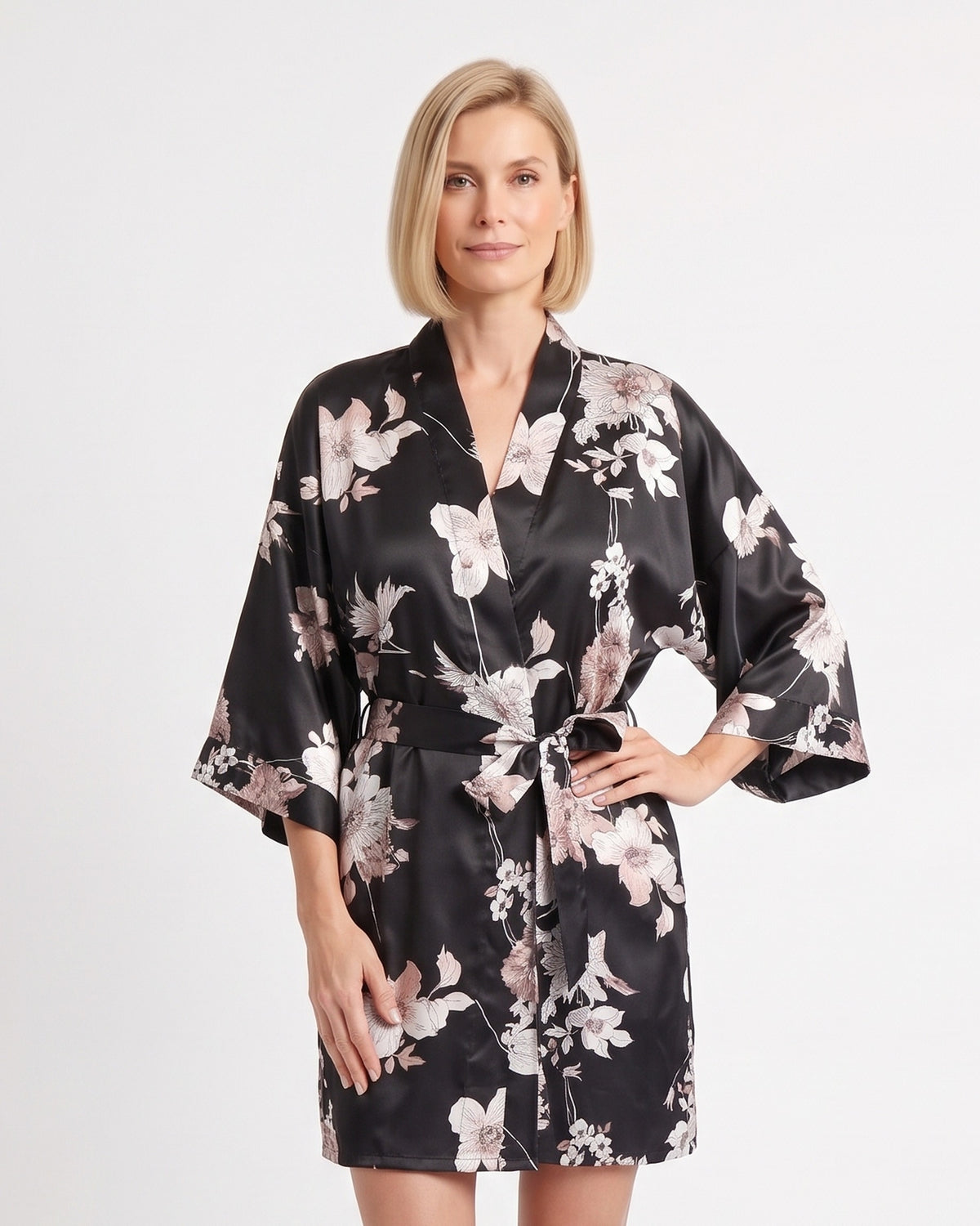 Short black satin robe with pale floral print, wide sleeves, and tie belt