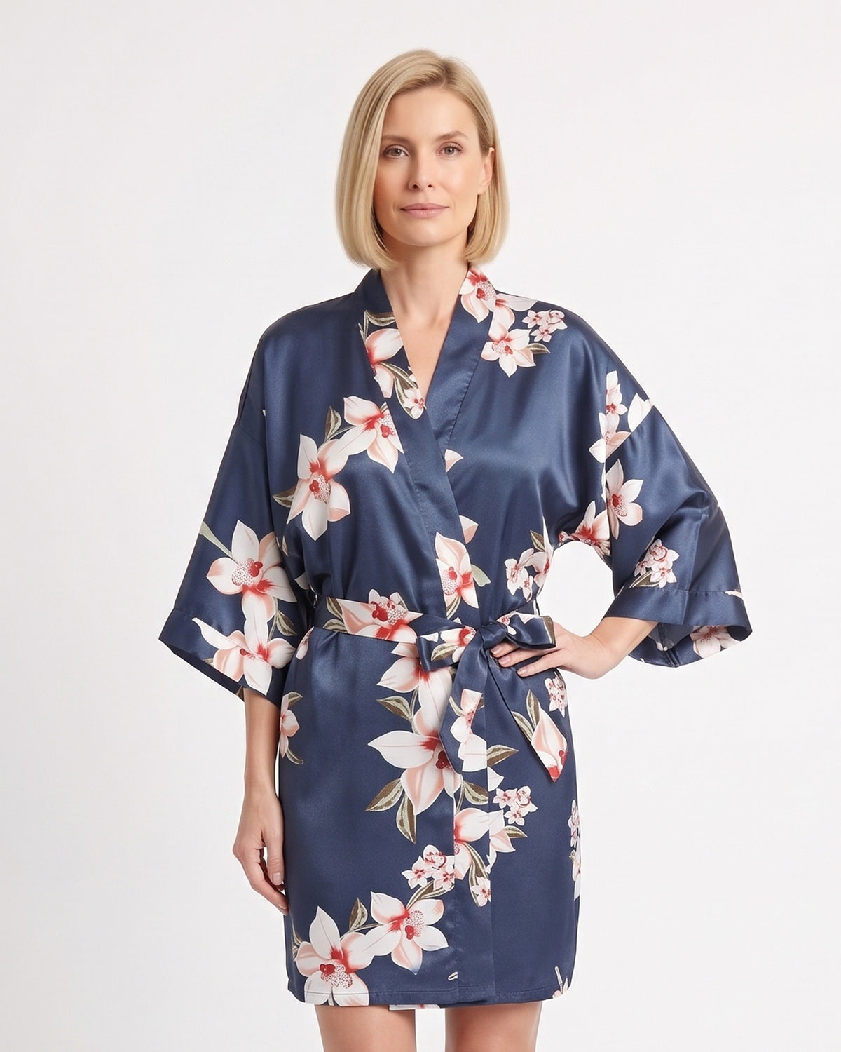 Short navy satin robe with pink and white floral print and a tie belt