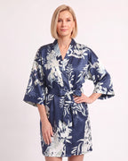Navy satin kimono robe with white floral print, elbow-length sleeves, and tie belt