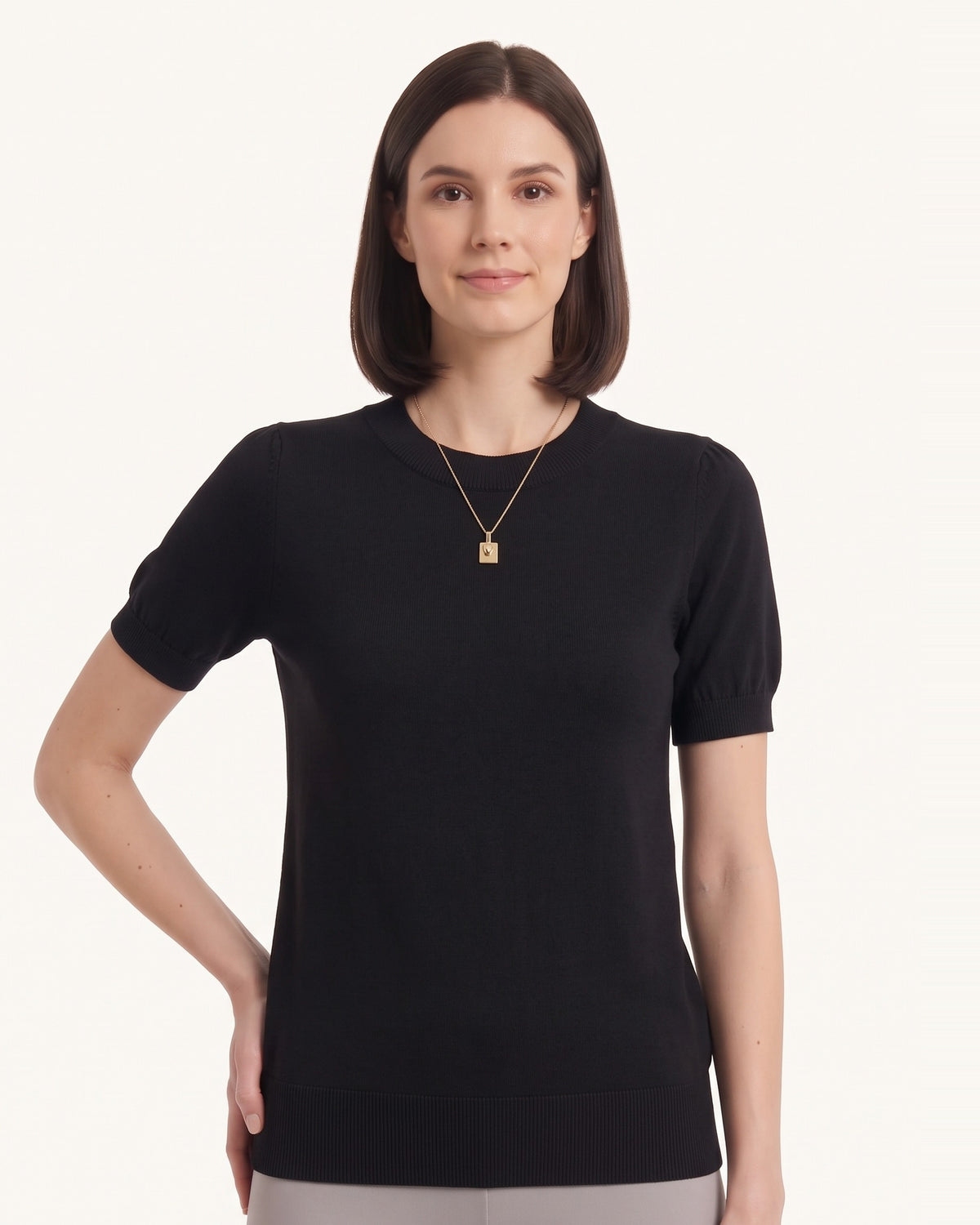 Black short-sleeve knit top with ribbed crew neck and banded hem, on model