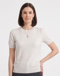 White short-sleeve knit top with ribbed crew neck and banded hem, on model