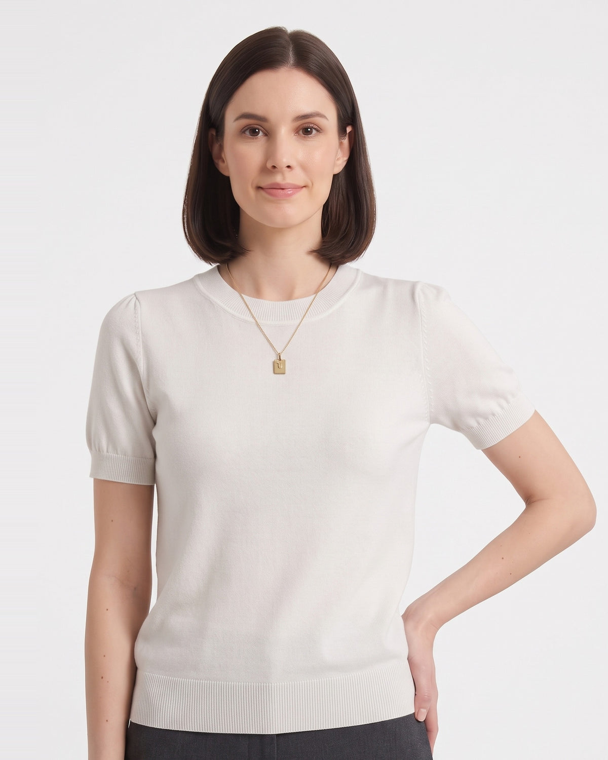 White short-sleeve knit top with ribbed crew neck and banded hem, on model