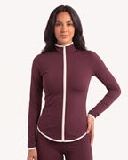 Burgundy slim-fit workout jacket with stand collar, full zip, and cream contrast piping.
