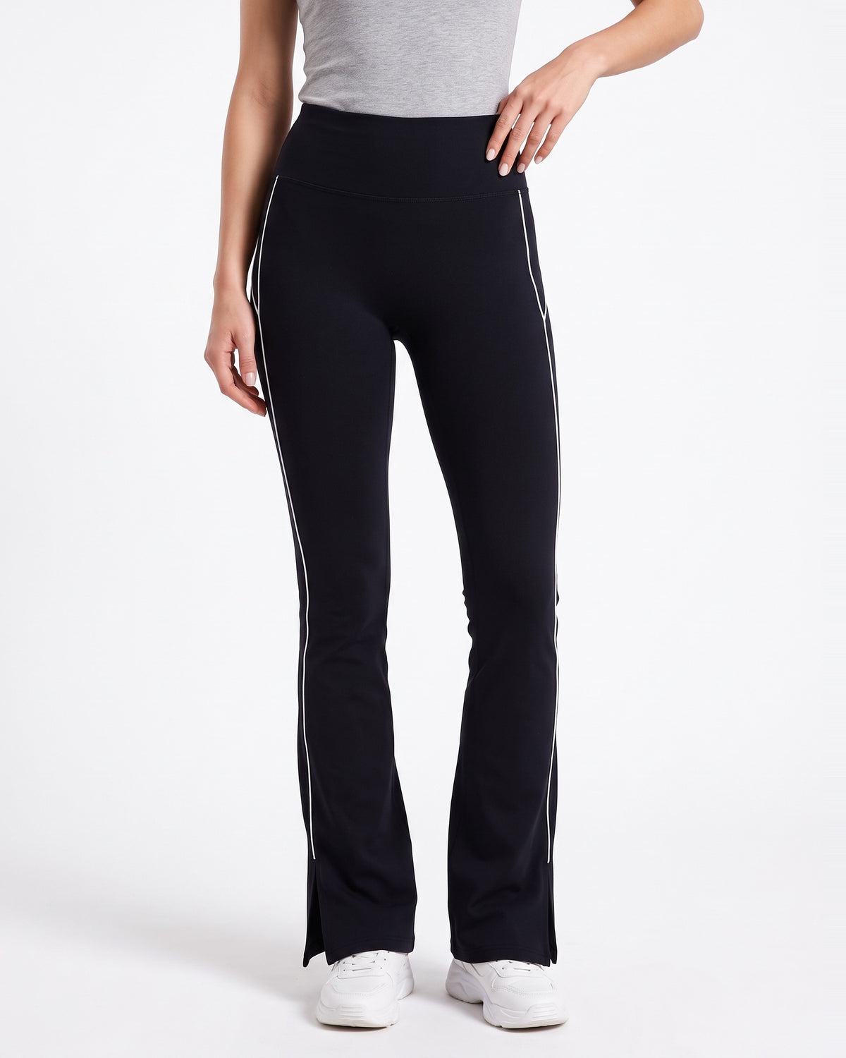 Black high-waisted flare leggings with split hem and contrast piping