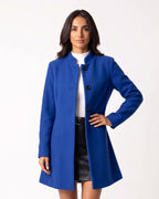 Women’s blue wool A-line dress coat with stand collar and button front.