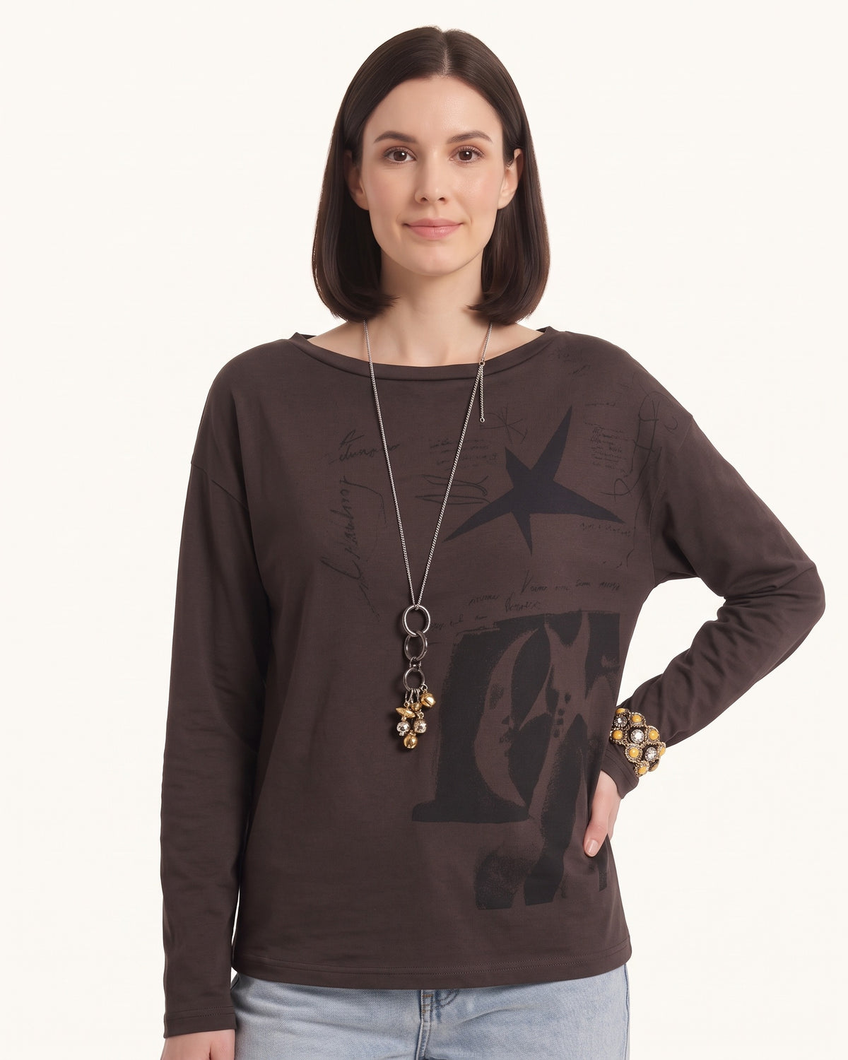 Dark brown long-sleeve graphic tee with star motif on chest, relaxed crew neck