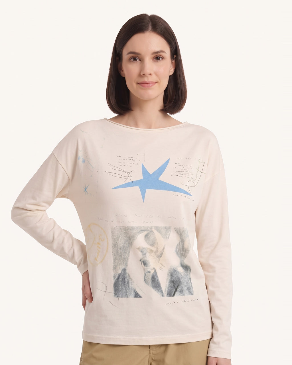 Cream long-sleeve graphic tee with blue star and photo-style graphic on chest