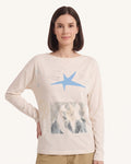 Cream long-sleeve graphic tee with blue star and photo-style graphic on chest