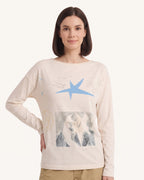 Cream long-sleeve graphic tee with blue star and photo-style graphic on chest