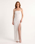 Strapless white maxi dress with ruched bodice, draped wrap skirt and high slit