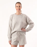 Women’s heather light gray knit pullover with matching drawstring shorts set, studio pose