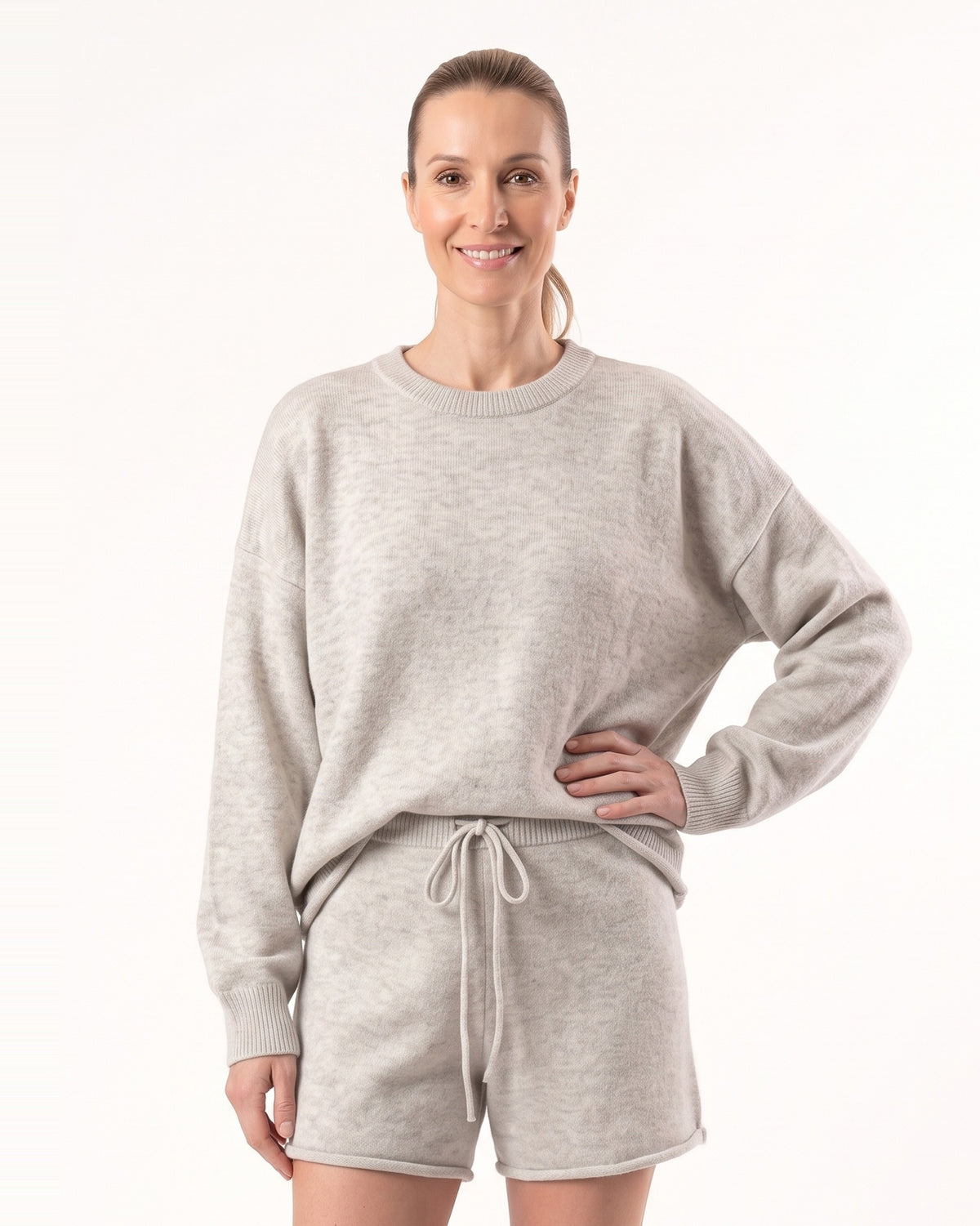 Women’s heather light gray knit pullover with matching drawstring shorts set, studio pose