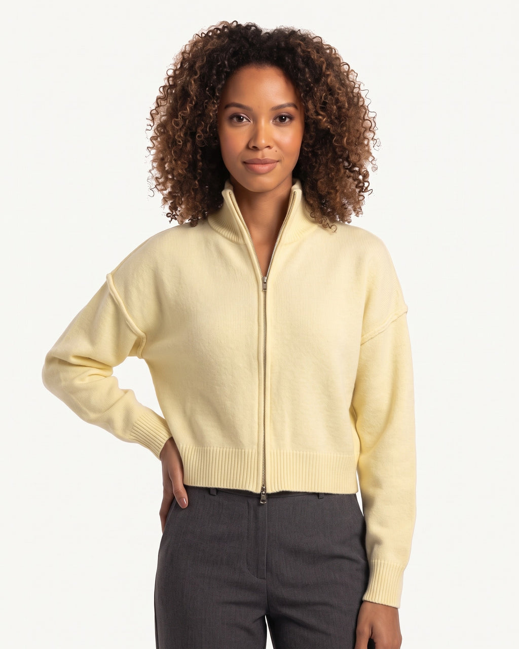 Cream cropped zip-up sweater jacket with stand collar, ribbed cuffs, drop-shoulder sleeves