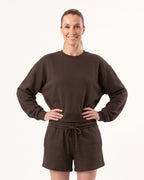 Dark brown crew neck sweatshirt with matching drawstring lounge shorts on a model.
