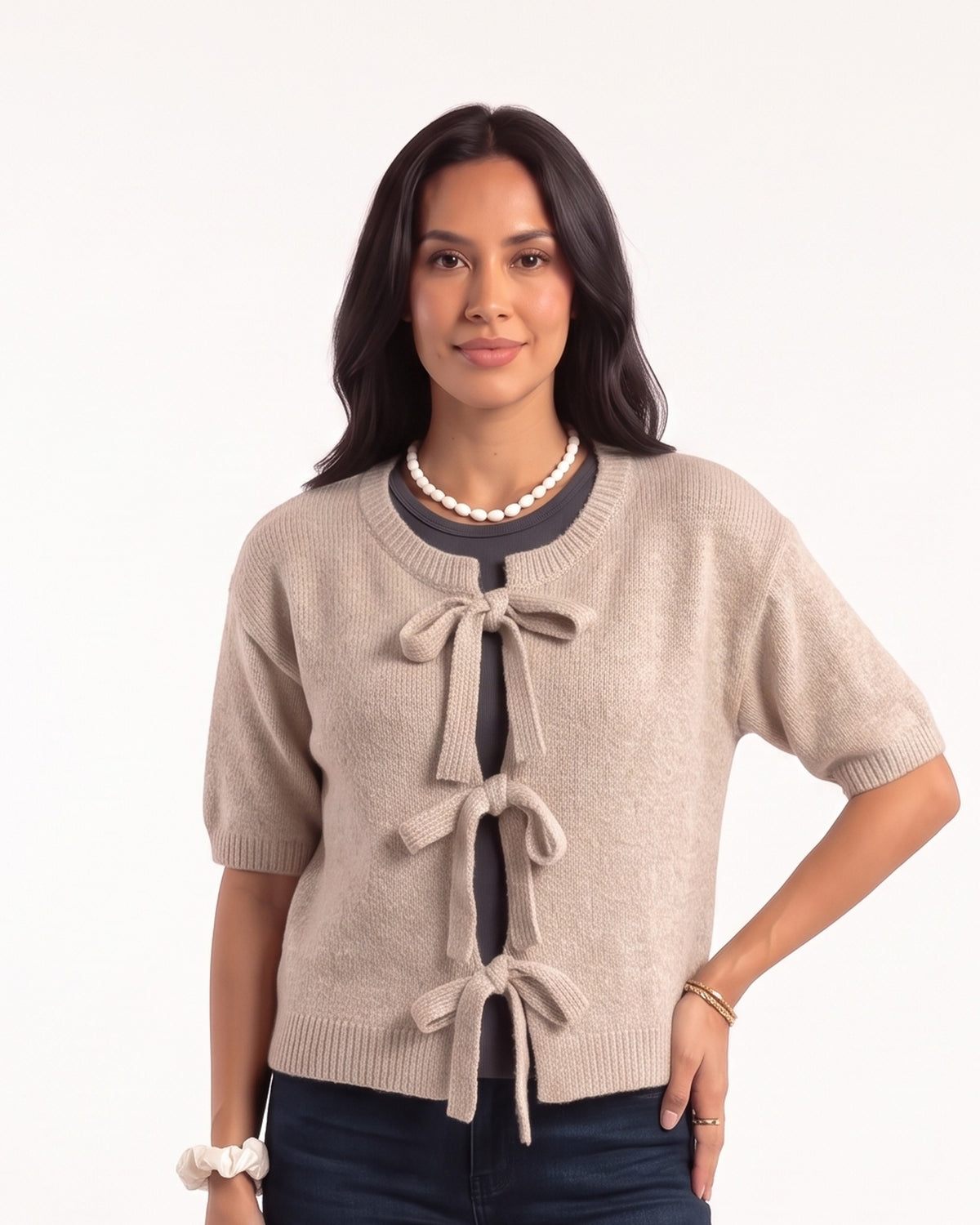 Beige cropped knit cardigan with three tie bows at the front and short sleeves
