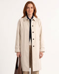 Beige trench coat with point collar, button front, and relaxed shoulders