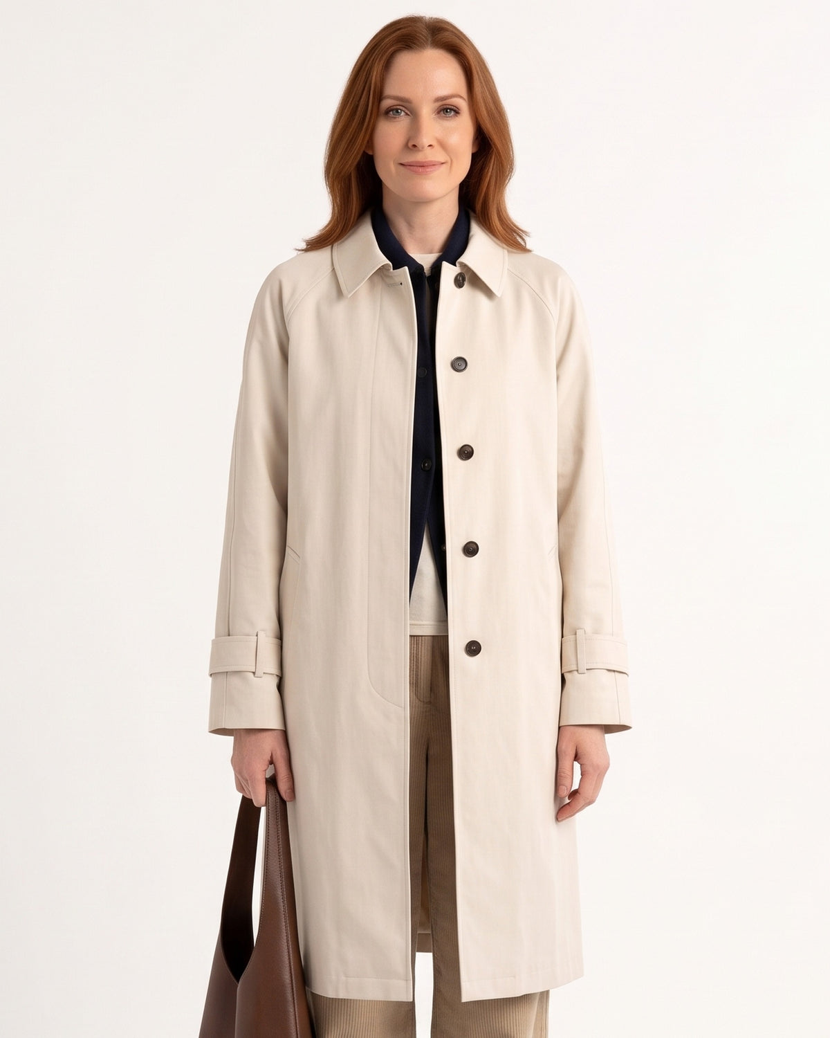 Beige trench coat with point collar, button front, and relaxed shoulders