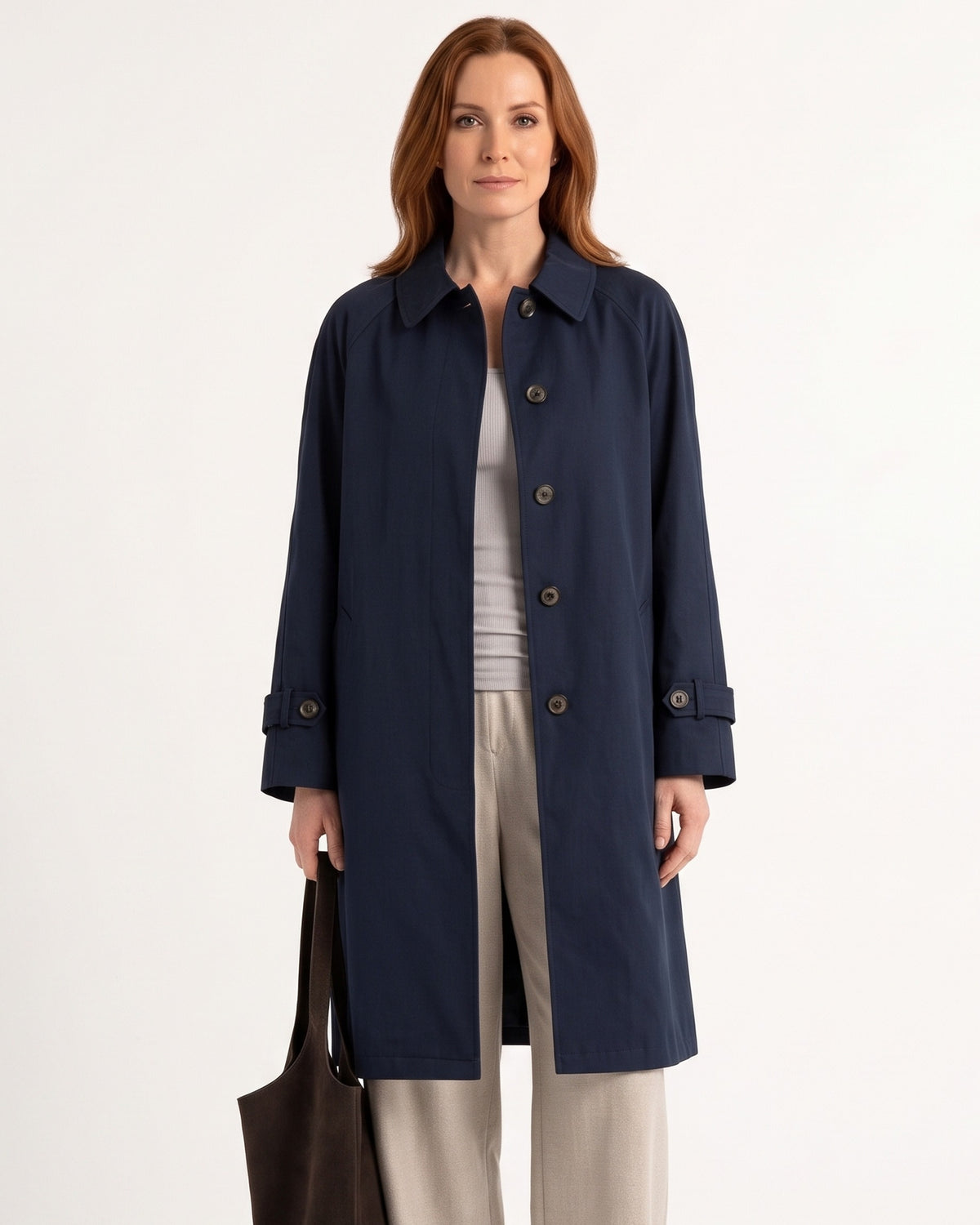 Navy mid-length trench coat with point collar, button front, and epaulet accents
