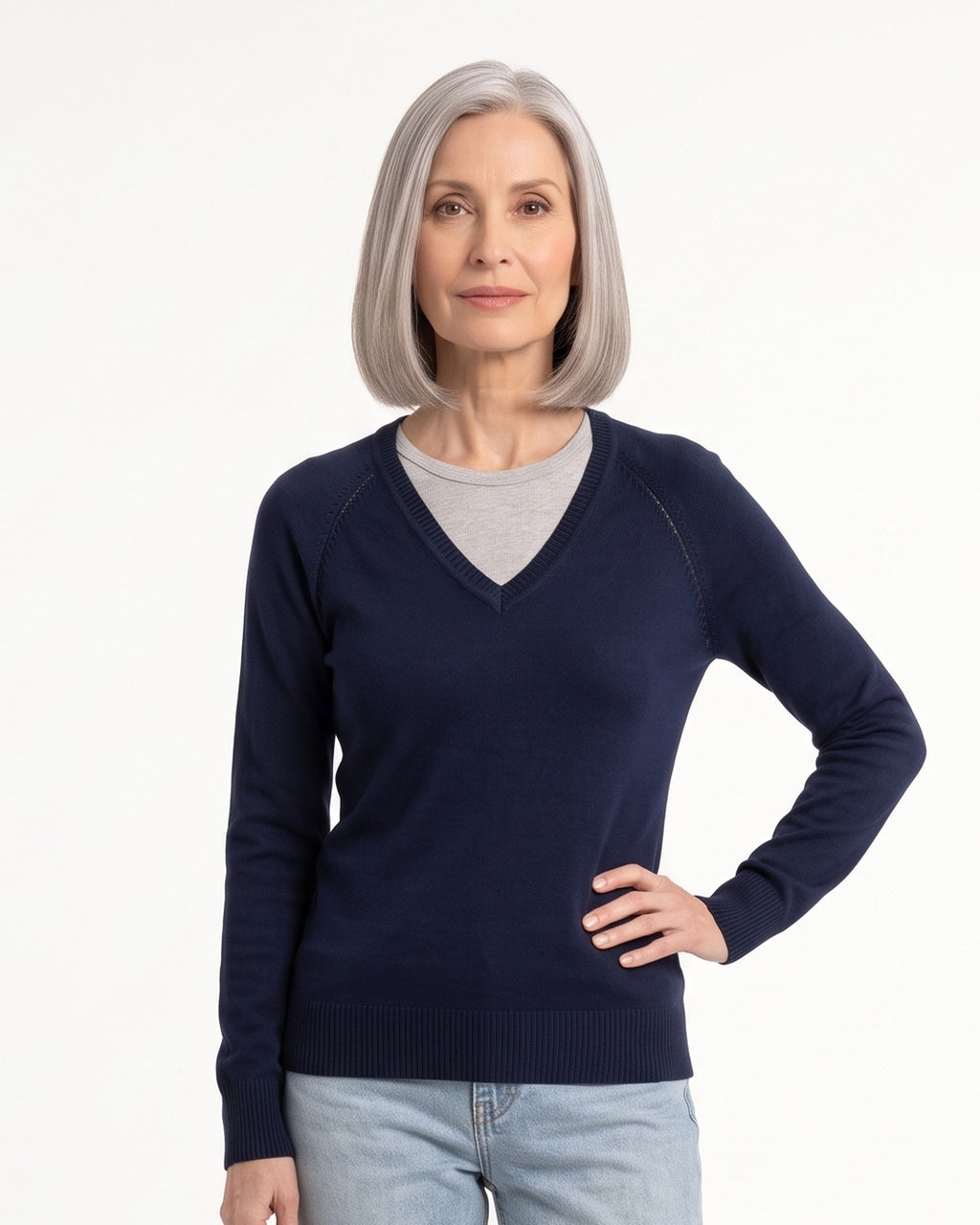 Women’s navy V-neck fine-knit sweater with long sleeves, worn with jeans