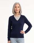Women’s navy V-neck fine-knit sweater with long sleeves, worn with jeans