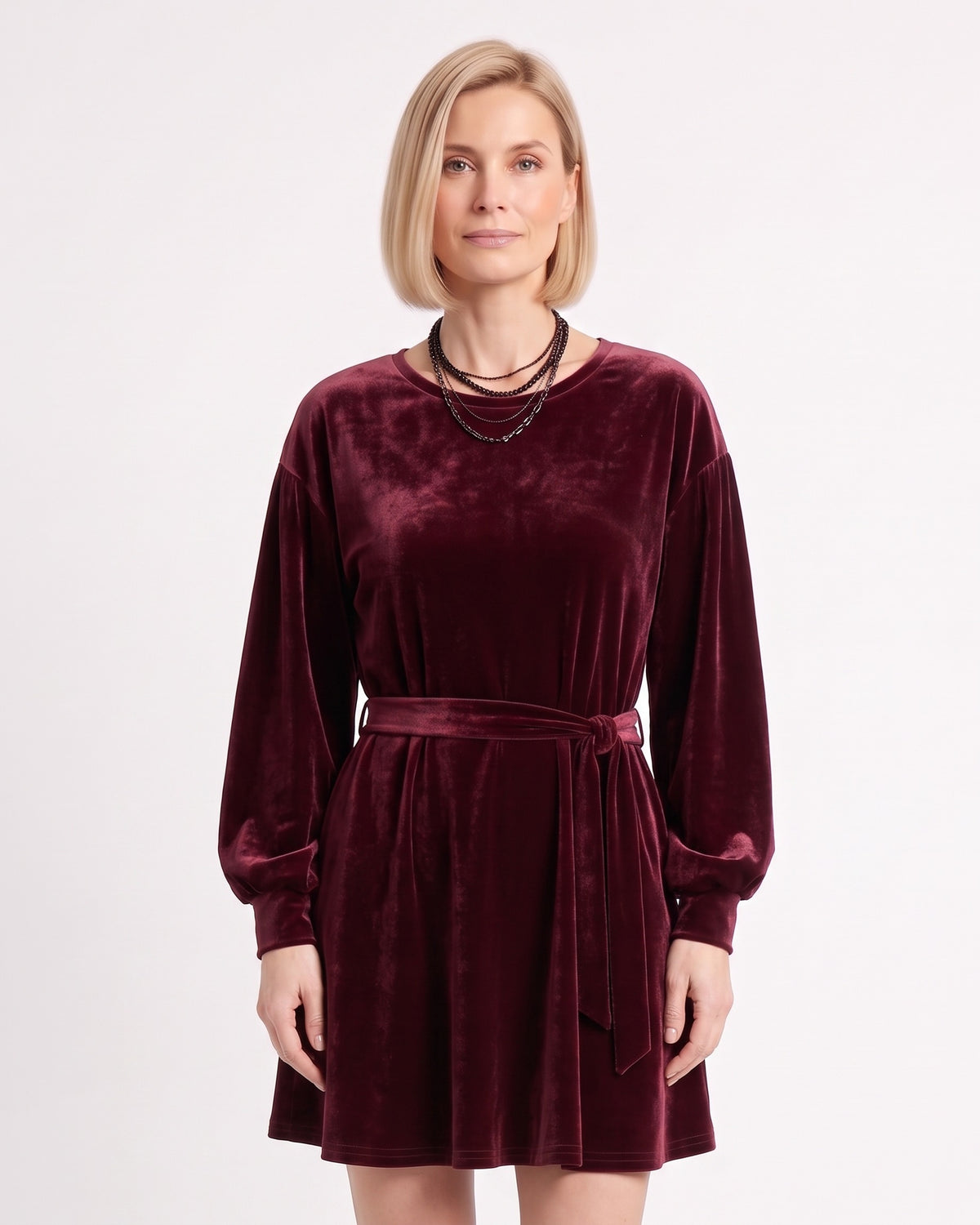 Burgundy velvet mini dress with round neck, tie waist, and long lantern sleeves