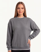 Gray waffle-knit crewneck sweatshirt with long sleeves and ribbed hem trim