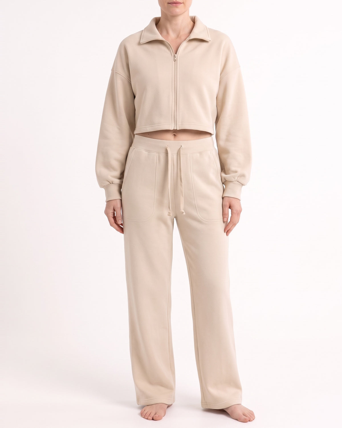 Beige wide-leg sweatpants with drawstring waist and front patch pockets, cotton blend