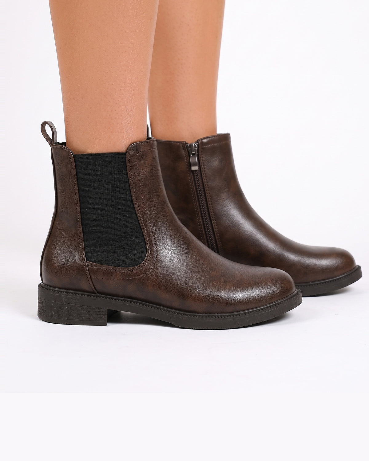 Brown chelsea boots with elastic side panels and side zip; low block heel, ankle height