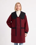 Women’s wool-blend coat in burgundy with oversized black collar and contrast pocket bands