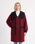Women’s wool-blend coat in burgundy with oversized black collar and contrast pocket bands