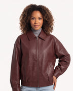 Burgundy faux leather bomber jacket with collared zip front and elastic hem