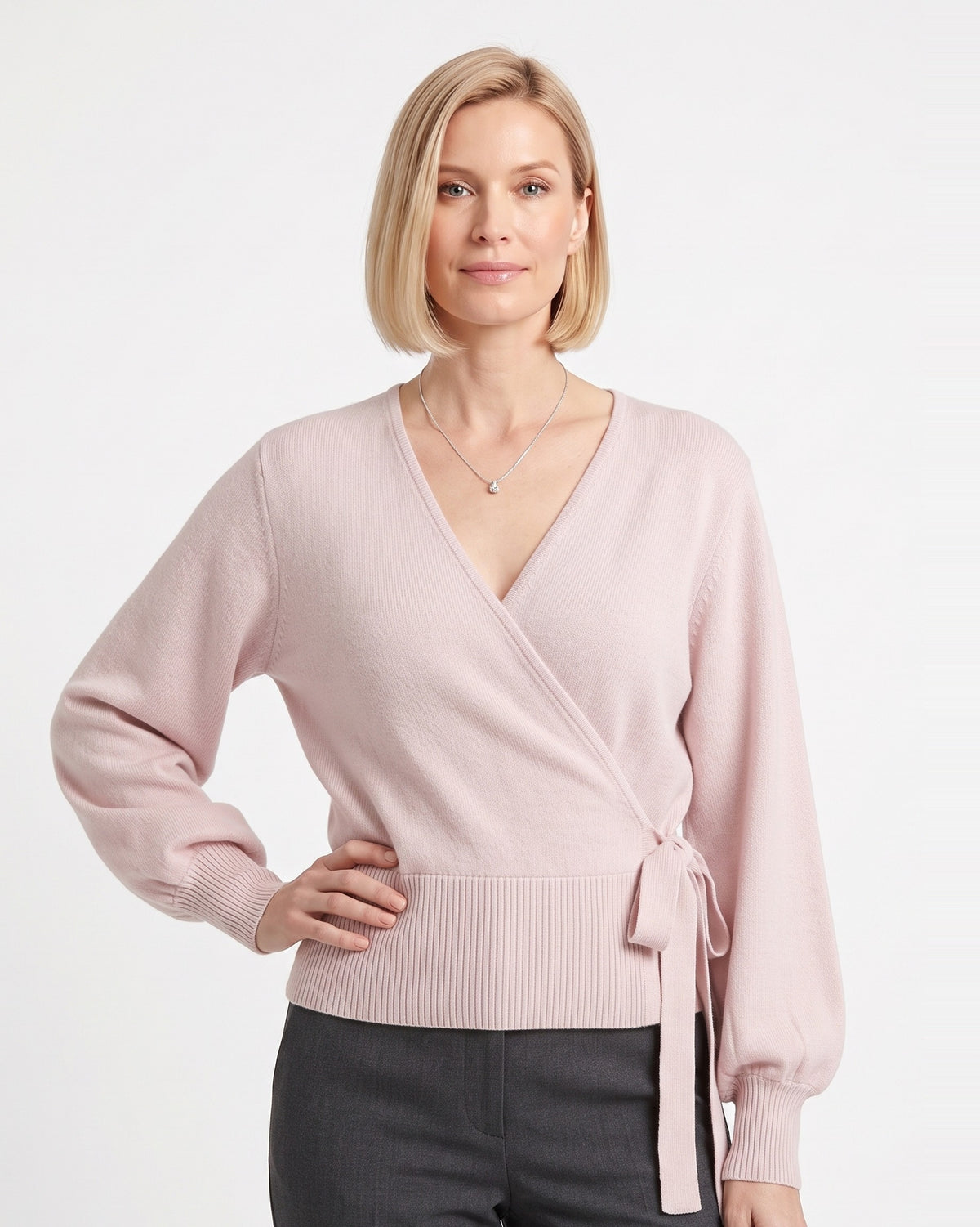Blush pink cropped wrap knit sweater with V-neck and side tie waist long sleeves