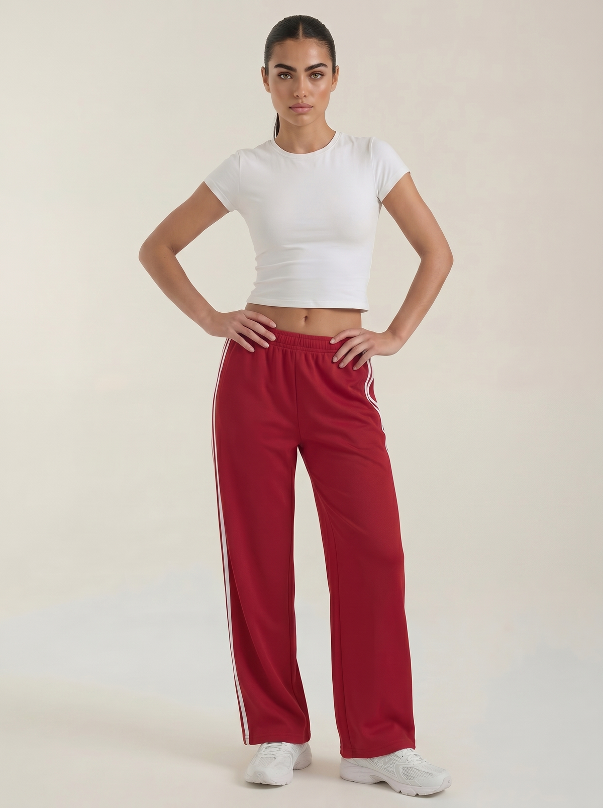 Red wide-leg track pants with elastic drawstring waist and white side stripes.