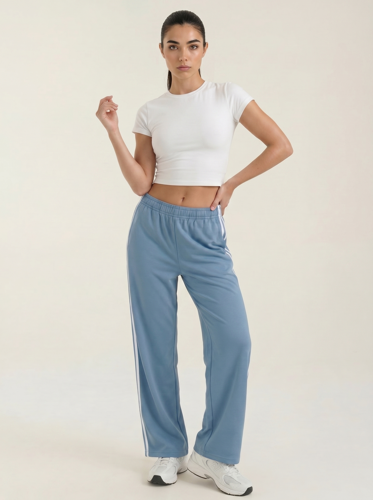 Blue wide-leg track pants with elastic drawstring waist and white side stripes.