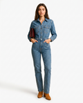 Blue denim jumpsuit for women, button front, chest pockets, waist belt, straight legs, side pose.